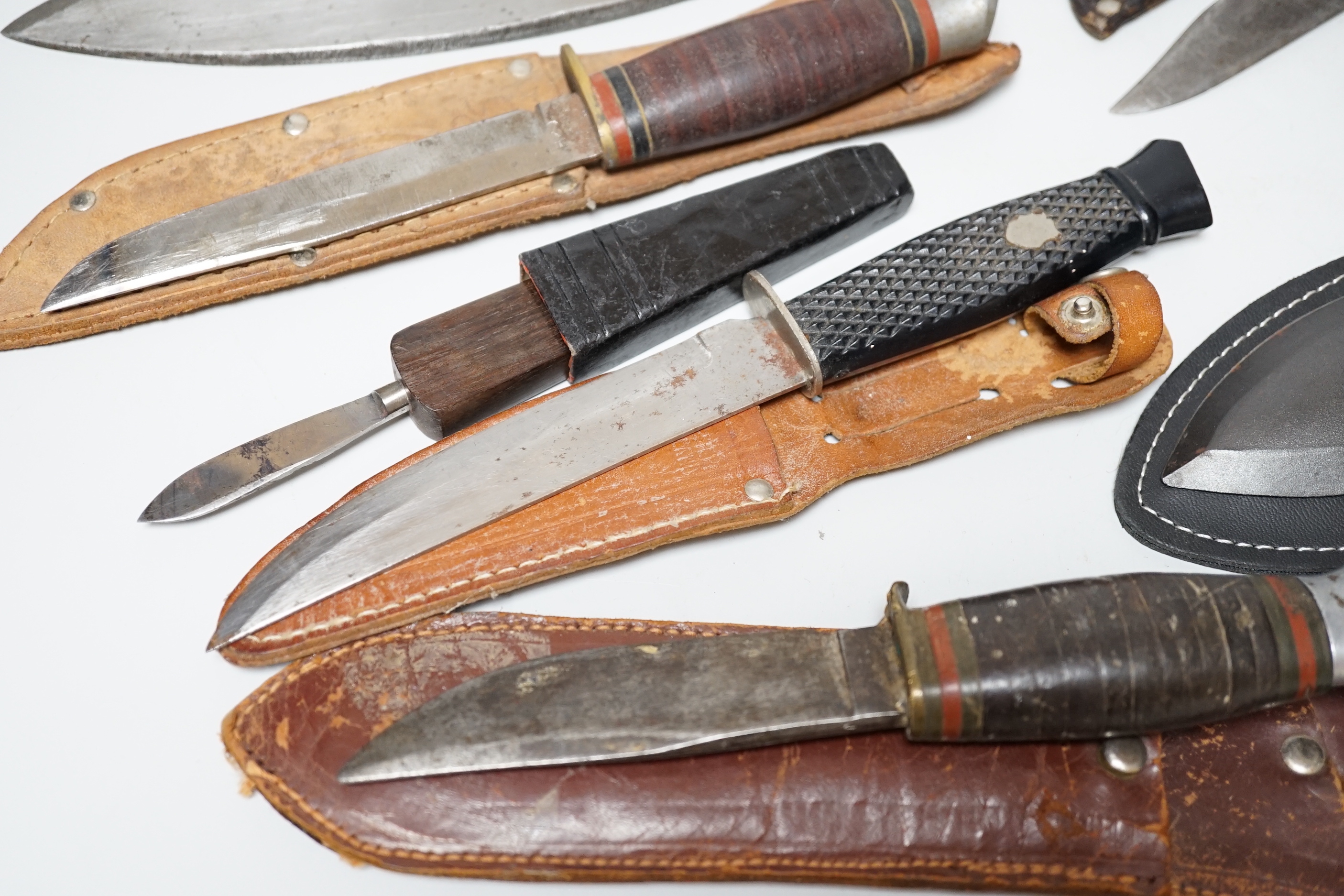 Eight knives including hunting knives, and bone handled Kukri example, the largest 42cm in length